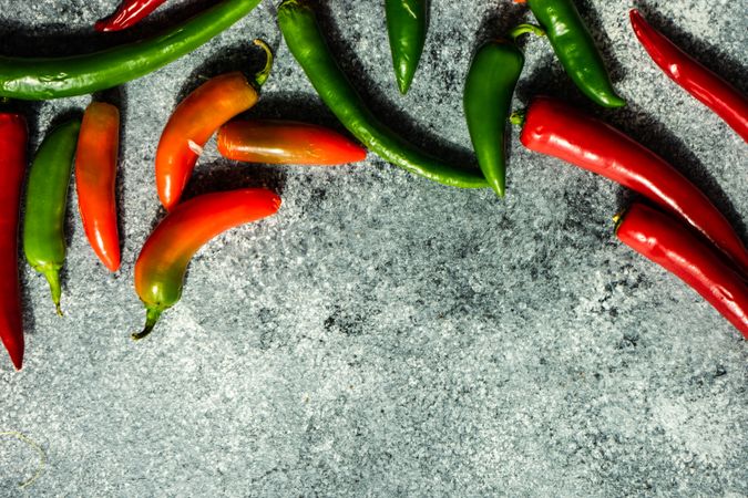 Spicy peppers on grey counter with copy space