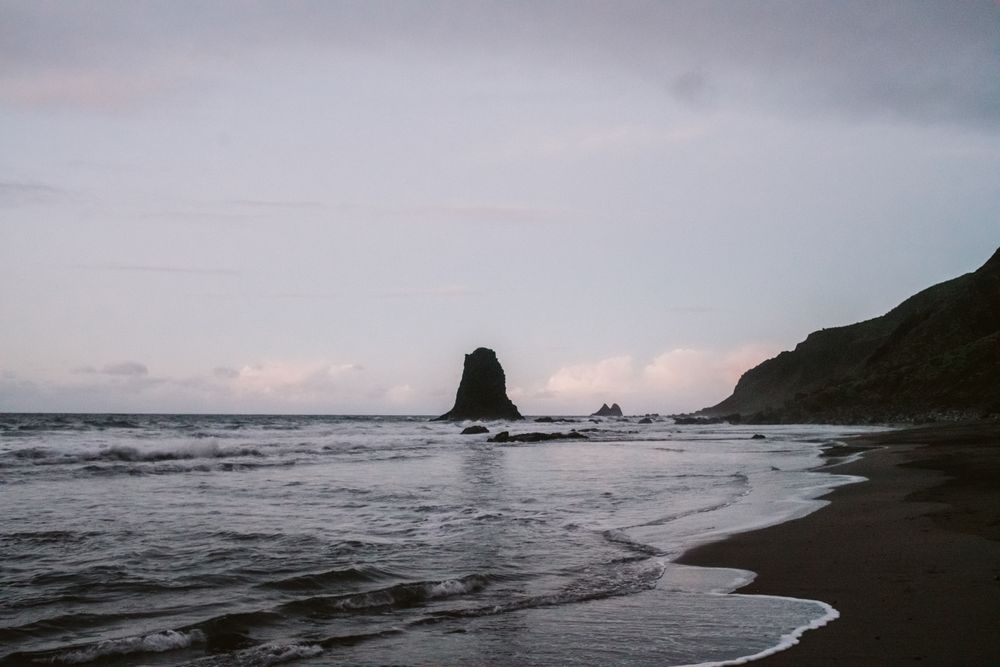 Lonely cliff in sea on cloudy day