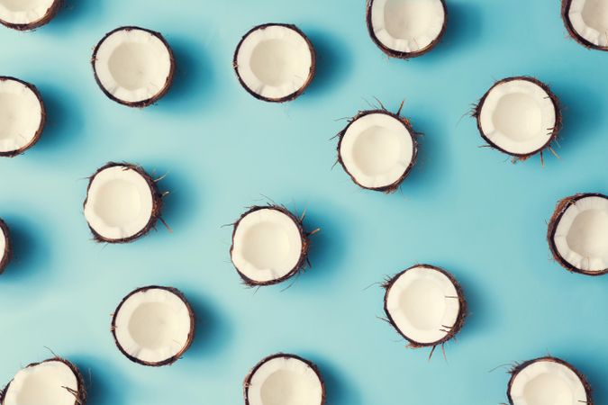 Coconut halves pattern on a pastel blue background