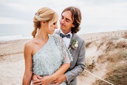 Happy young married couple spending time together at seaside