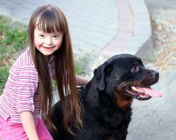 Smiling girl with Down syndrome and her dog