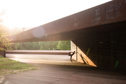 young woman stretching leaning in a amazing geometrical building