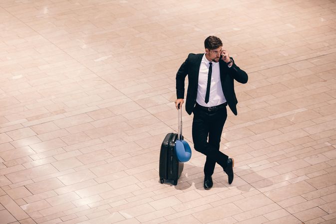 Business traveler making a phone call while waiting for his flight