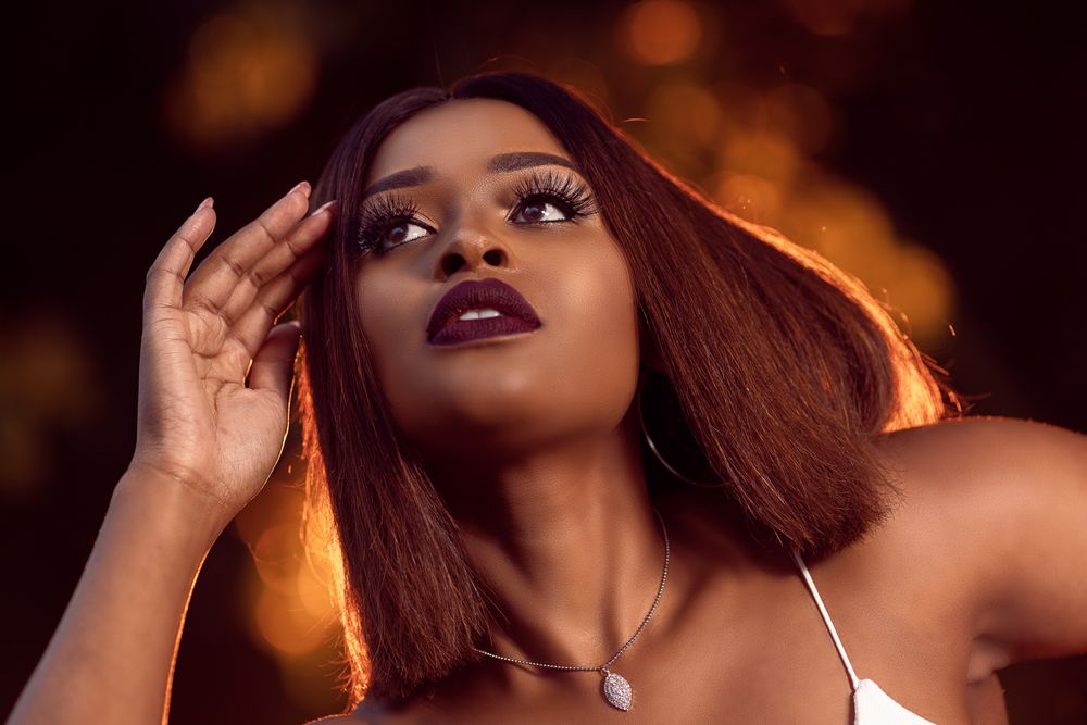 Young woman with purple lipsticks looking up