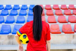 Female soccer player with armband with LGBT pride flag