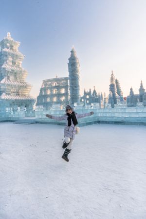 Cheerful female near ice oriental temple