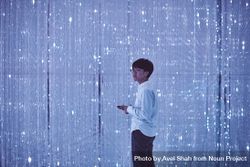 Tokyo, Japan - November 19th, 2019: Young man standing in crystalline art installation 4ZeDN5