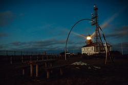 Road and lighthouse in evening