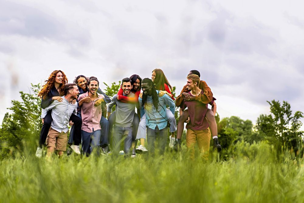 Friends piggybacking in the countryside - view from the grass