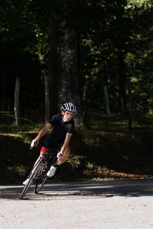 Professional cyclist riding bike in park