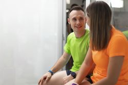A couple of gym trainees talking during a break