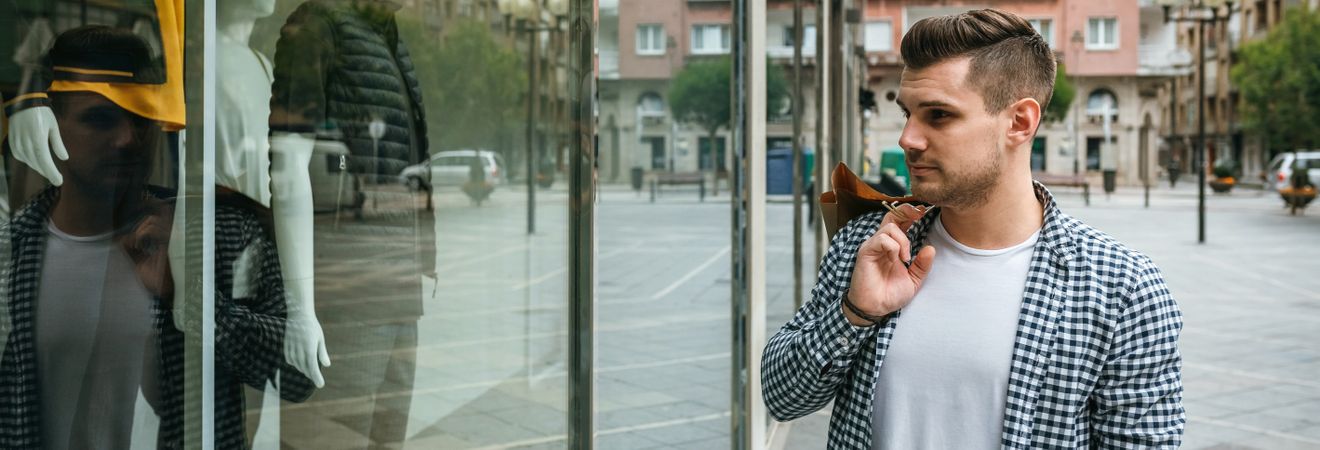 Man looking at the showcase of a store