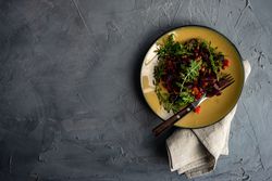 Top view of yellow plate of beet salad served with copy space