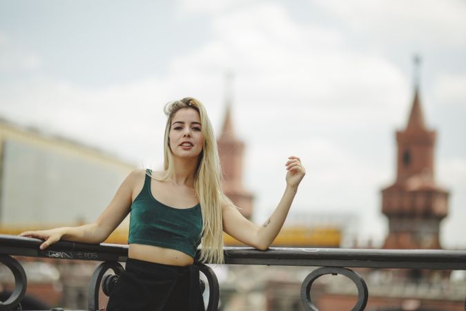 Blonde woman leaning on railing