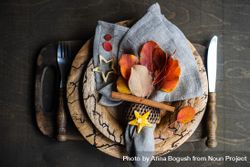 Autumnal table setting with yellow and red leaves on rustic background with copy space 4ME2r4