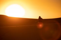 Anonymous photographer standing in desert