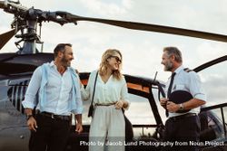 Couple alighted from a helicopter thanking pilot 4d8qyr