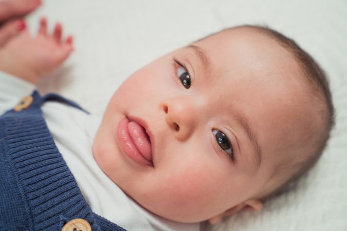 newborn lying on bed