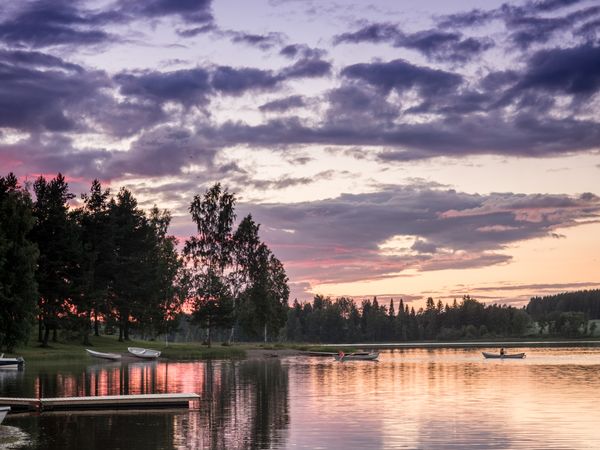 Sunset landscape with boats in river forest