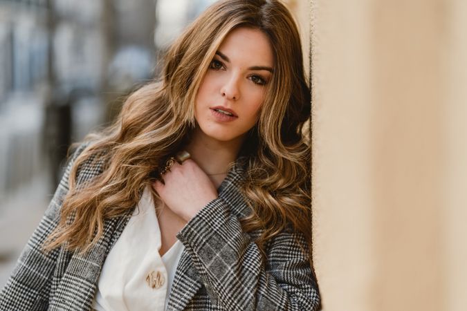 Woman leaning on wall on street