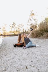 Female friends taking selfie on beach