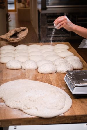Photo detail of a baker's hands working the bread dough