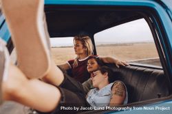 Two women sleeping in car with a friend driving bYZJG0
