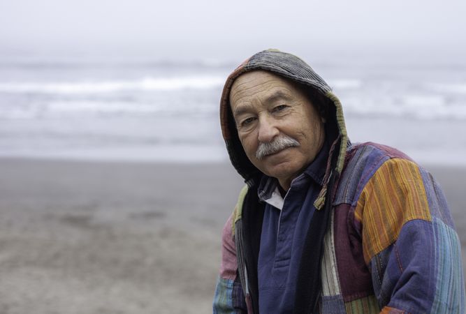 Mature man on empty ocean seashore