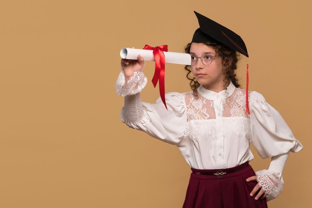 Graduate in cap and gown holding diploma scroll