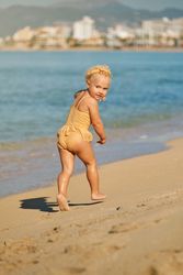 Happy girl playing on beach