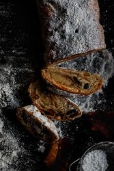 Pieces of Stollen near sieve and autumn leaves