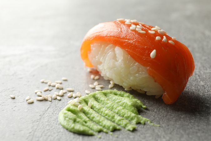 Delicious sushi roll and wasabi on gray background. Japanese food