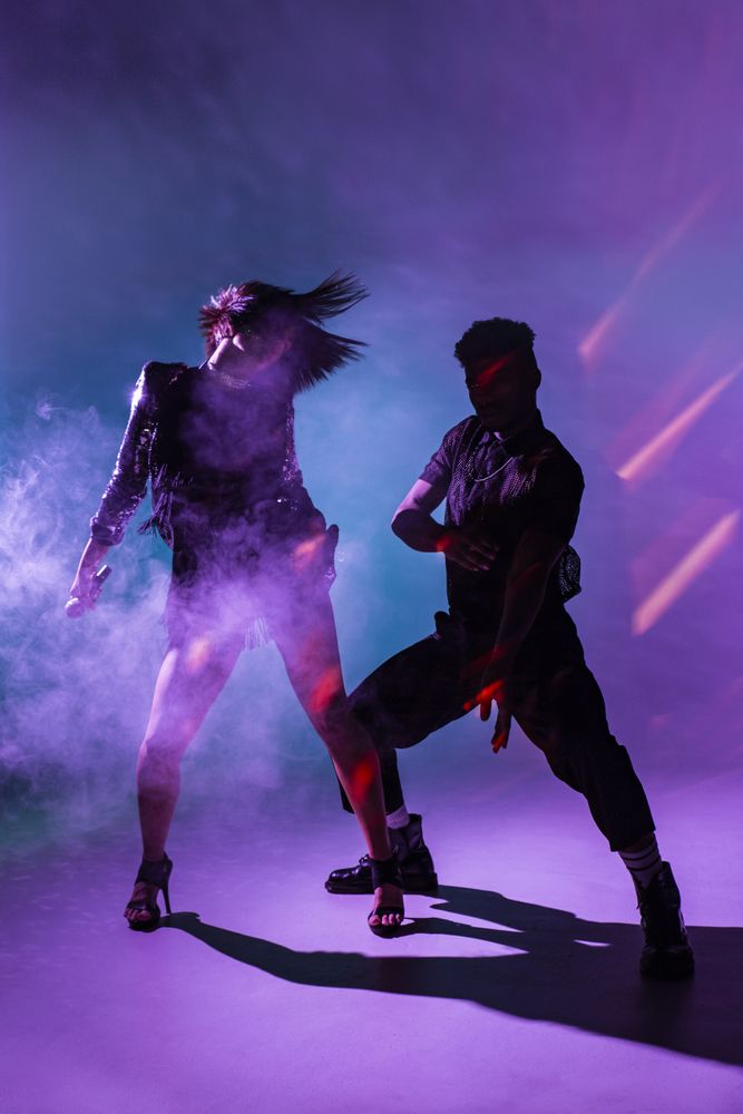 young dancers near smoke