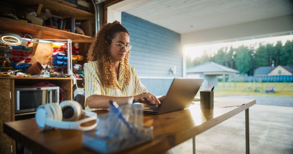 Successful Female Digital Entrepreneur Running An E-commerce Startup From Home, Checking Emails, Filling Online Orders, Researching Market.