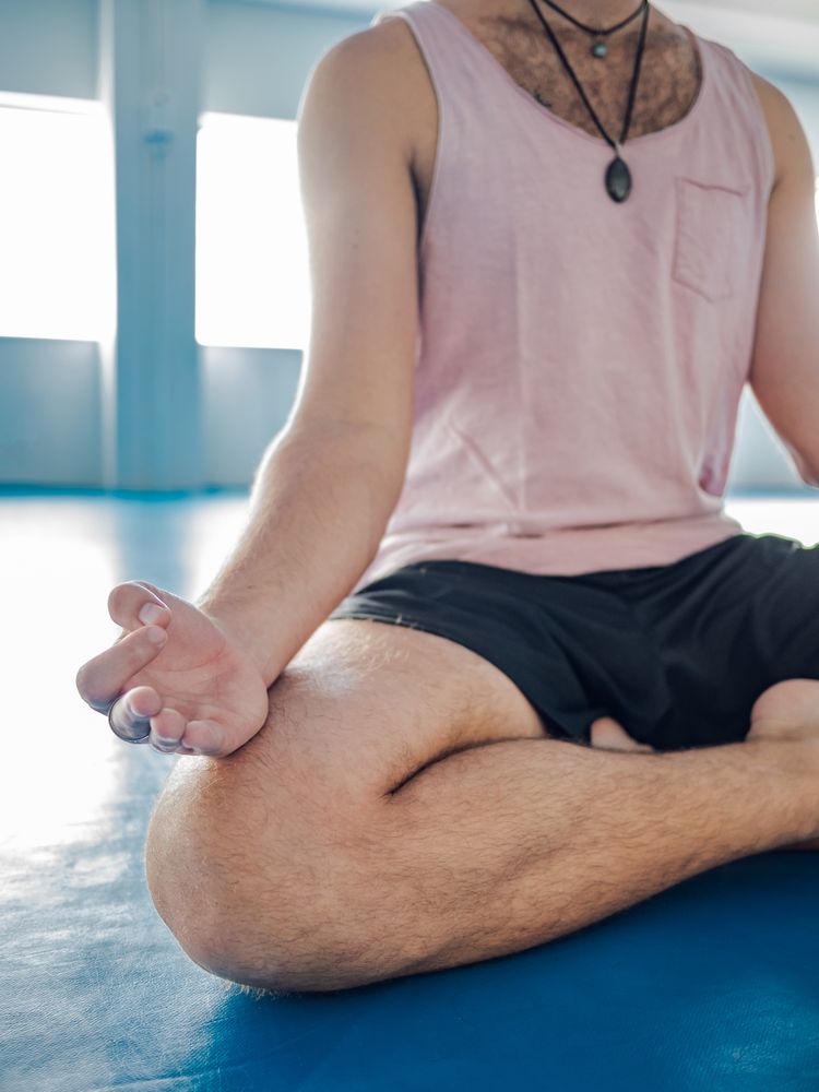 Male meditating in spacious room