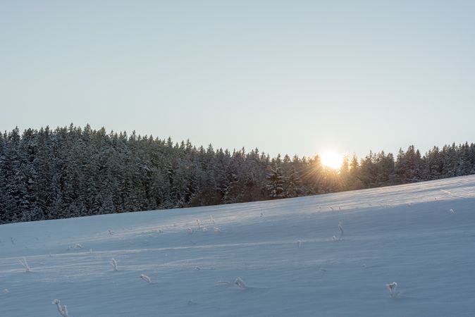 Winter scenery at sunrise in mountains on a beautiful day of December