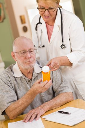Doctor or Nurse Explaining Prescription Medicine to Man