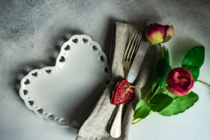 St. Valentine's Day card with plates, silverware, heart ornaments and tulips