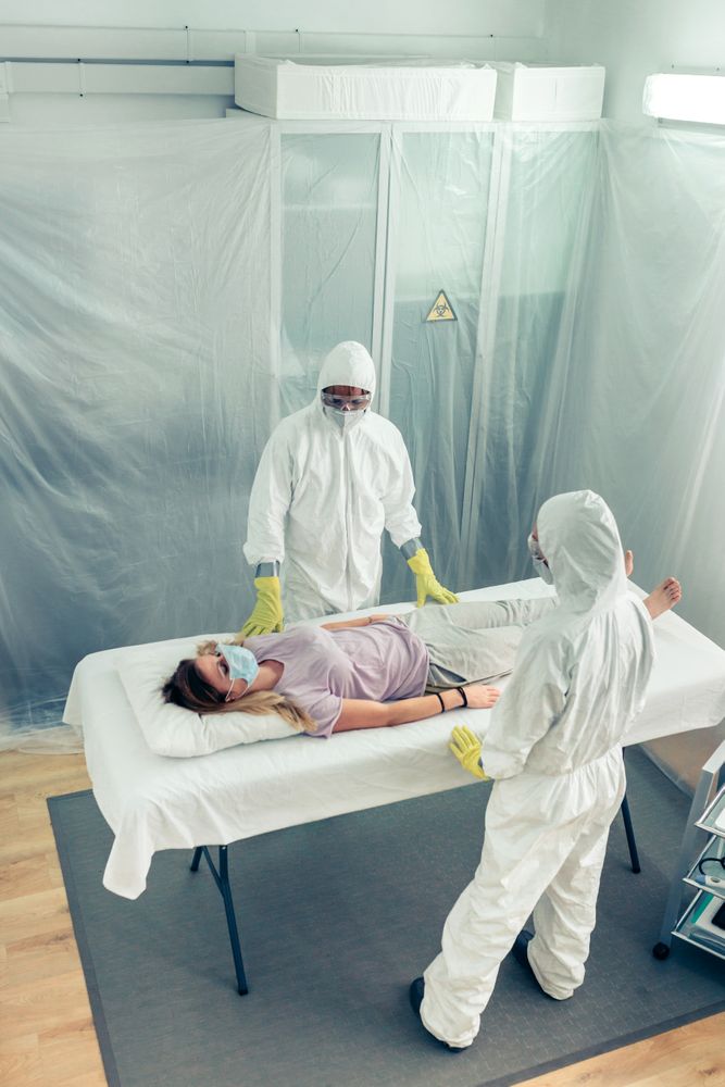 Doctors in a field hospital observing a patient