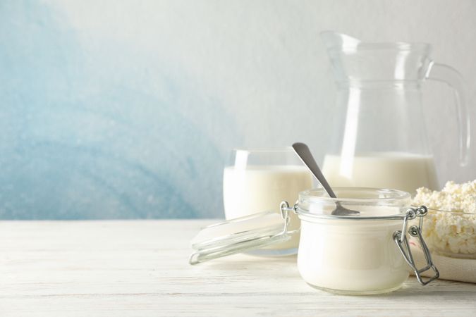 Different dairy products on wooden background, copy space