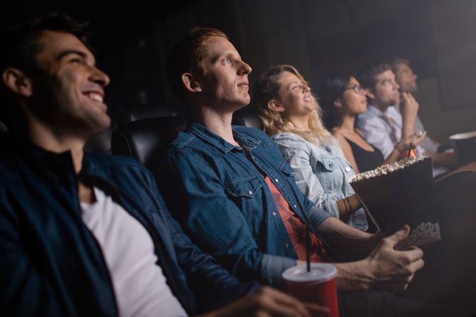 Friends watching a movie in the movie theater