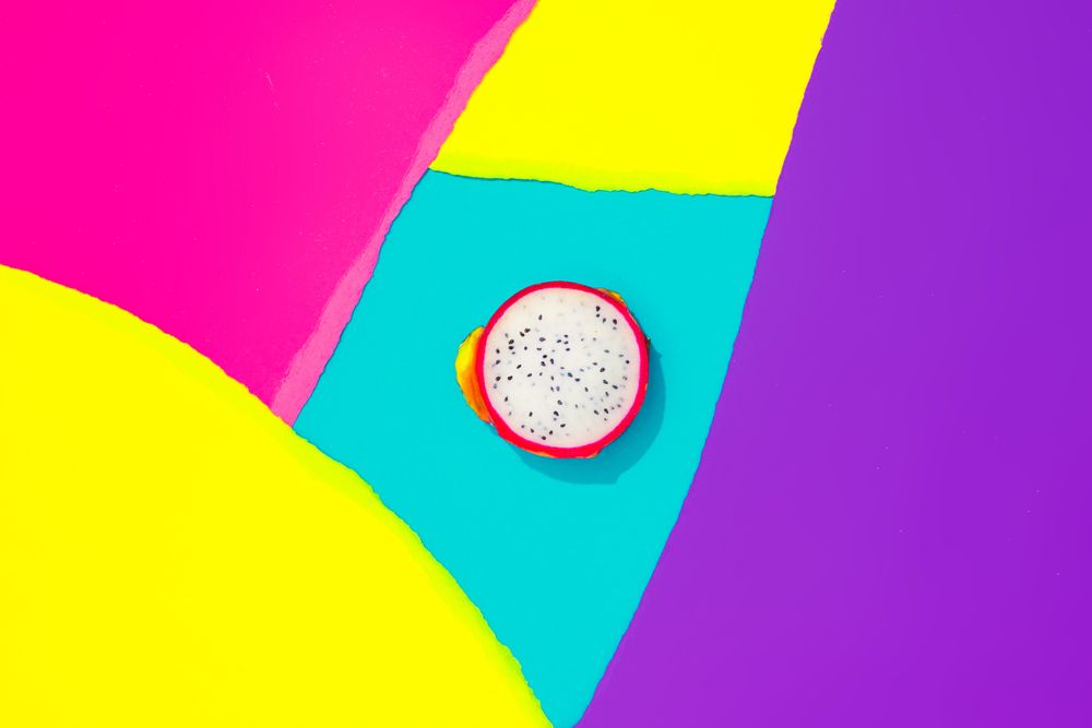 Draganfruit on pattern of ripped paper in vivid colors