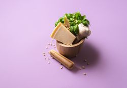 Green pesto ingredients in a mortar
