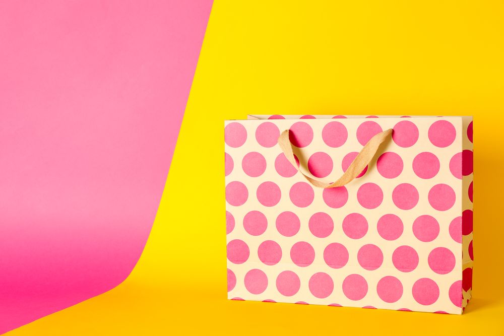 Paper bag on multicolor background, space for text
