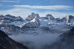 Foggy day in snowy mountains