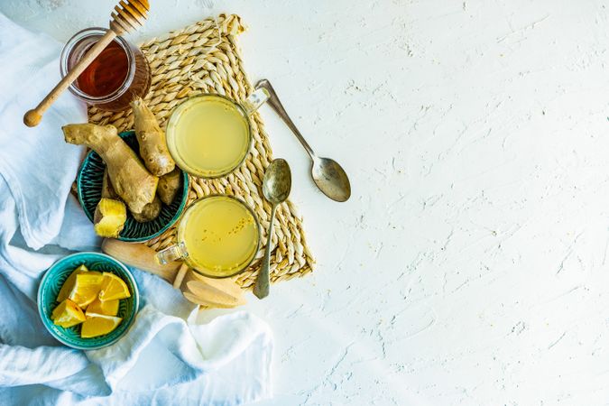 Ginger detox drink on placemat with ingredients with copy space