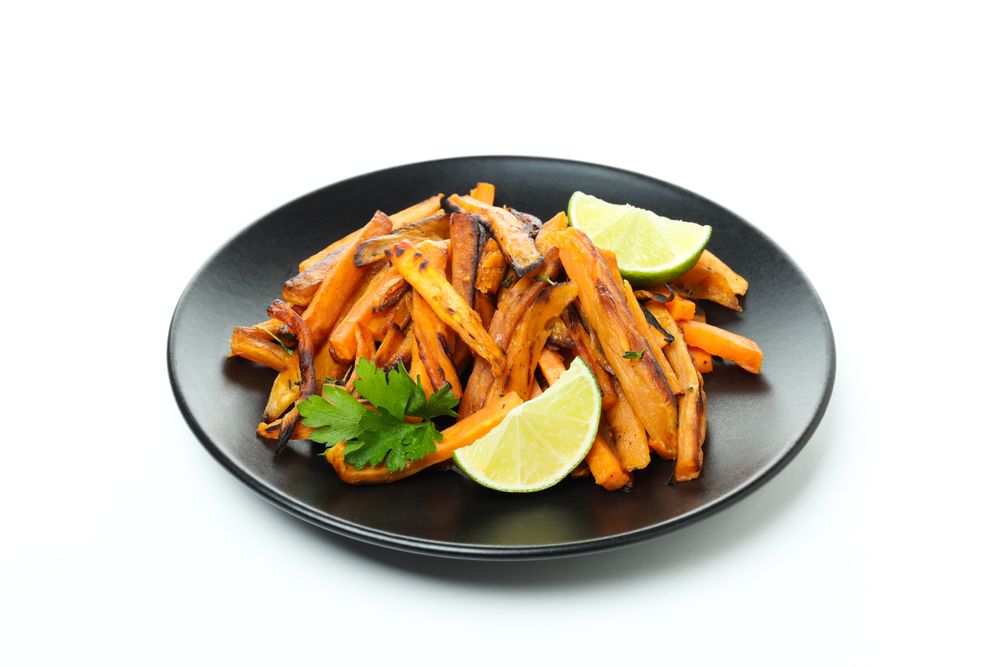 Concept of tasty food - sweet potato fries, isolated on light background