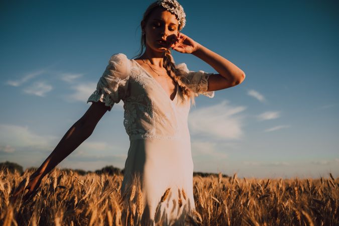 Woman in middle of wheat field
