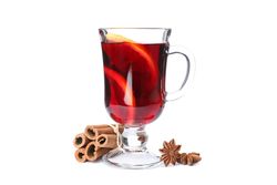 Glass of mulled wine with orange and cinnamon isolated on blank background