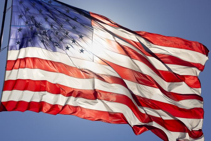 Dramatic Backlit American Flag Waving in the Wind.